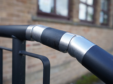 A black rail that shows a close up of the connector. The connector is a silver metal.