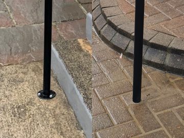 Black metal handrail posts shown with optional fixing methods, including base plate and ground-fixed installation on outdoor paving.